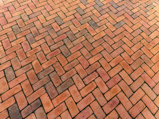 Wall Mural - Large tall background of grunge brick pavers laid in herringbone pattern, receding perspective backdrop for construction, horizontal aspect