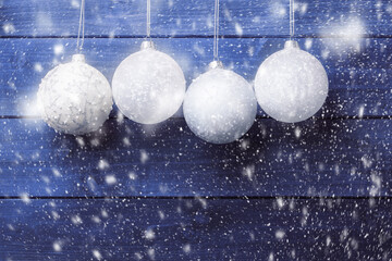 Wall Mural - Four Christmas balls over blue wooden background. Xmas and New Year background