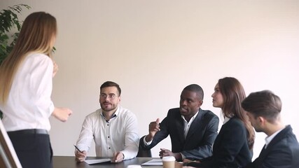 Canvas Print - Rear view female coach interact with participant of seminar black employee, staff sit at table in boardroom listen business trainer talking discuss brainstorming together, corporate education concept