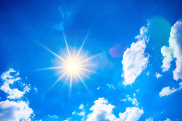 summer background, blue sky with clouds and bright sun