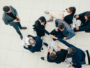 Wall Mural - young employees supporting each other with a handshake.