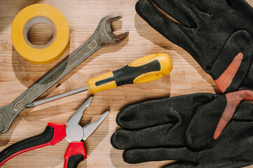 Building tools including centimeter ruler, wrench and cutter placed in the right side on wooden surface with open space. Top view composition. Measurement. Fixing and cropping. Hand tool. Tools for