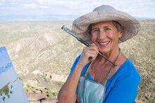 Senior Woman Artist Painting Landscape, White Rock, New Mexico