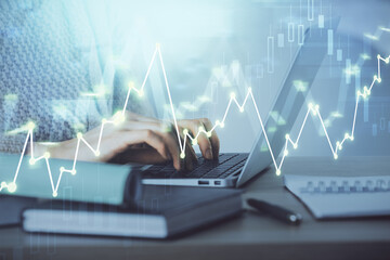 Double exposure of woman hands typing on computer and forex chart hologram drawing. Stock market analysis concept.