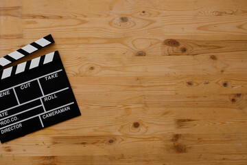 Filmmaking concept. Movie Clapperboard. Cinema begins with movie clappers. Movie clapper board on old wooden background.