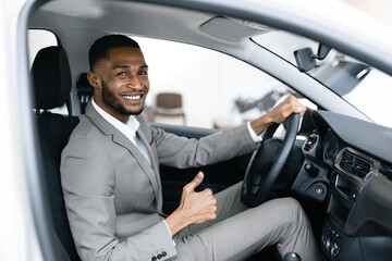 Wall Mural - African Businessman Gesturing Thumbs Up Sitting In Driver's Seat