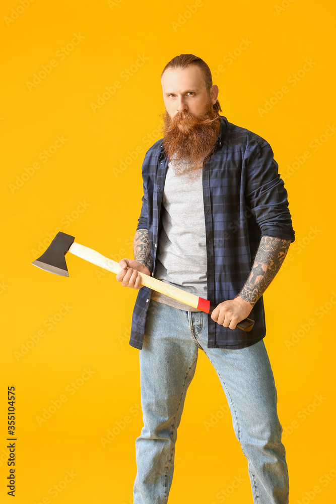 Handsome lumberjack on color background