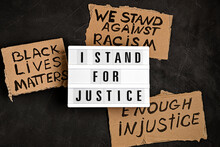 I Stand For Justice Text On Light Box And Other Anti Racism Slogans