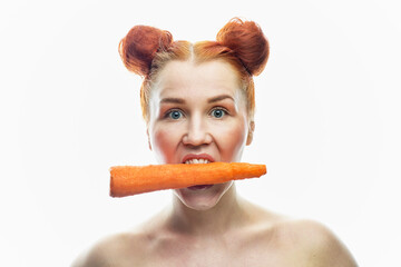 a close-up portrait of a red-haired girl with clear skin and a carrot in her hands. Isolated on a white background.