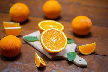 glass of fresh orange juice with fresh fruits on wooden table
