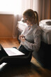 © JustLife - Young businesswoman working on lap top. Beautiful woman working in hotel room.