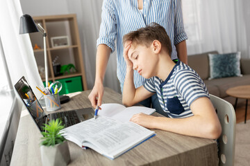 Sticker - education, family and homework concept - mother and son with book writing to notebook at home