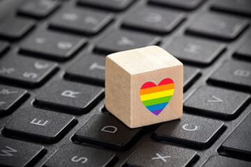 Poster - Wooden block with LGBT rainbow heart symbol of love on laptop keyboard.