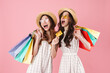 © Drobot Dean - Image of excited women holding sopping bags and credit card