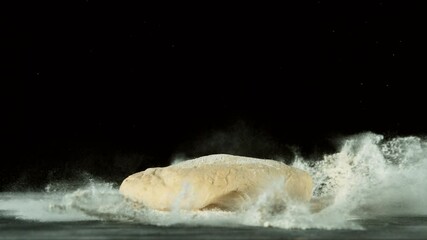 Wall Mural - Super slow motion of falling yeast dough into flour. Filmed on high speed cinema camera, 1000 fps.