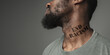 © master1305 - Close up black man tired of racial discrimination has tattooed slogan end racism on his neck. Concept of human rights, equality, justice, problem of violence and racism, discrimination. Flyer.