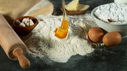 Wall Mural - Super slow motion of raw egg falling into pile of flour. Filmed on high speed cinema camera, 1000 fps.