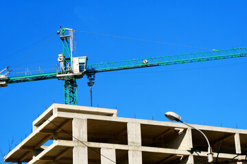 Wall Mural - Crane. Self-erection crane over construction site. Crane near bulding.