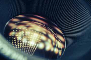 Aufkleber - Beautiful Camera Lens on a dark with yellow shine reflection light background. Macro view.