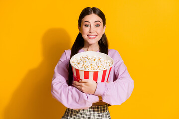 Canvas Print - Portrait of candid funny crazy teen girl hold embrace big pop corn box while watching series wear checkered pullover isolated over bright shine color background