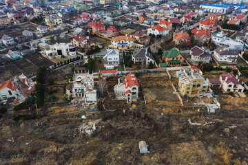 Wall Mural - Landslide caused by rains of hurricane destroyed expensive cottages and houses. Destroyed house, cottage, large cracks, chips, slabs. Broken asphalt shifted landslide after earthquake. View from drone