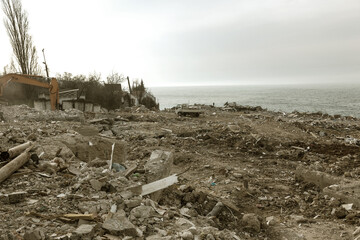 Wall Mural - Landslide caused by rains of hurricane destroyed expensive cottages and houses. Destroyed house, cottage, large cracks, chips, slabs. Broken asphalt shifted landslide after earthquake. View from drone