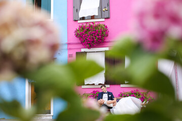 Wall Mural - wedding couple posing near colorful houses in burano