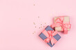 © Nana_studio - Gift or gift box and stars confetti on a pink table from above. Flat composition for birthday