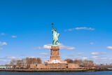 Fototapeta Miasta - The Statue of Liberty under the blue sky background, Lower Manhattan, New York City, United state of America, Architecture and building with tourist concept