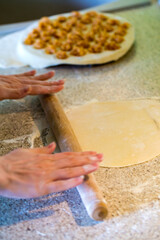 The process of making homemade dumplings. The cook rolls the dough cooking dumplings with chicken