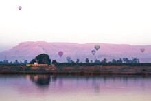 Nile River At Sunrise With Hot Air Balloons In Luxor, Egypt.
