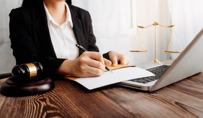 justice and law concept.Male judge in a courtroom on wooden table and Counselor or Male lawyer working in office. Legal law, advice and justice concept.