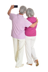 Wall Mural - Senior couple taking selfie isolated on white background