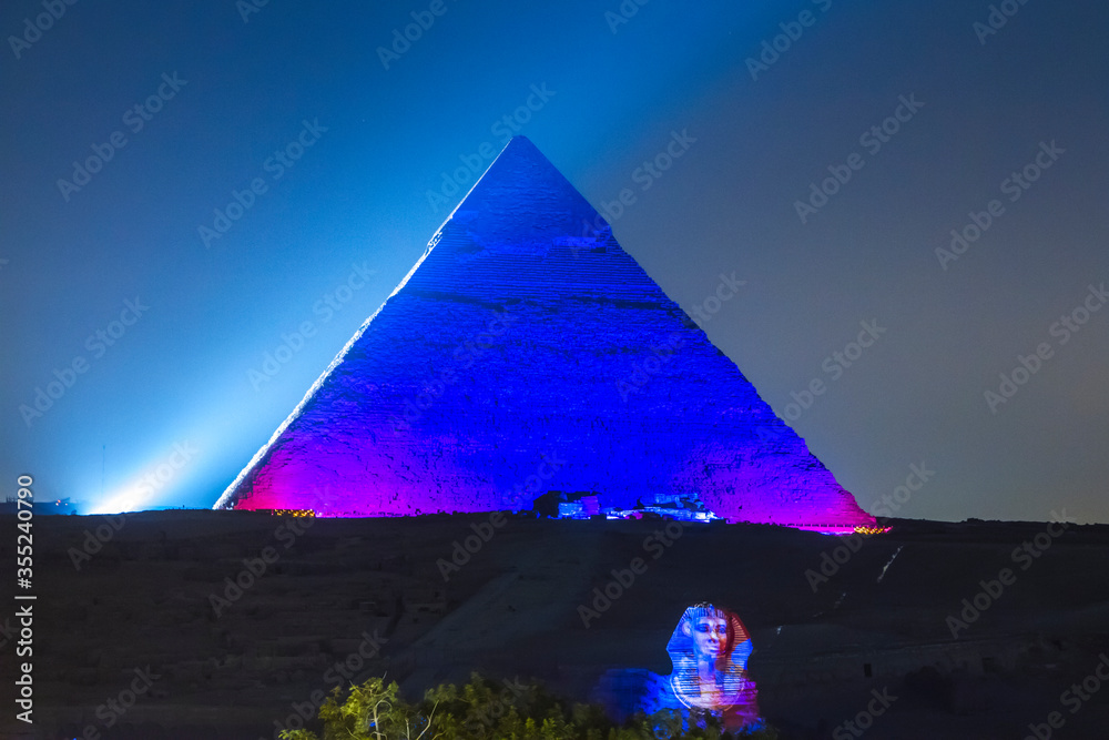 Great Pyramid of Giza illuminated at night, UNESCO World Heritage site, Cairo, Egypt. - obrazy, fototapety, plakaty 