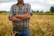 © Kitreel - Close up of a mature male farmer with arms crossed proud with his work on a wheat grain field used for biological and ecological natural cereal farming and organic cultivation ready for harvesting.