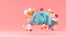 Blue Camera Surrounded By Colorful Balls On A Pink Background.-3d Render.