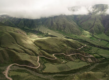 Aerial View Of Cuesta Del Obispo In Salta, Argentina. Curved Road Along The Mountain Slope, Covered By Green Grasses