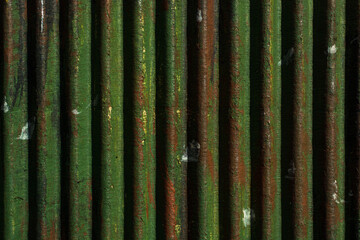 Wall Mural - Corrugated texture with vertical convex lines of brown and green color