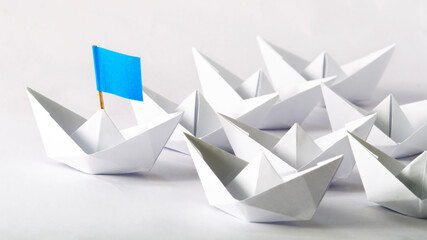 to strive against another. business competition, concept using origami paper boats.
