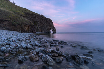 Wall Mural - Beautiful sunset on the shore of Lake Baikal. View of a natural stone arch