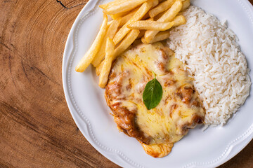 Parmegiana Steak also known as Filet Parmegiana. .Accompanied by rice and chips