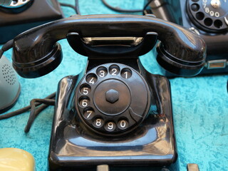 Vintage rotary dial telephones on display in flea market Turin Italy June 8 2019