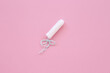 white hygiene tampon on a pink background