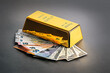 Gold bullion and banknotes of dollars and euros.