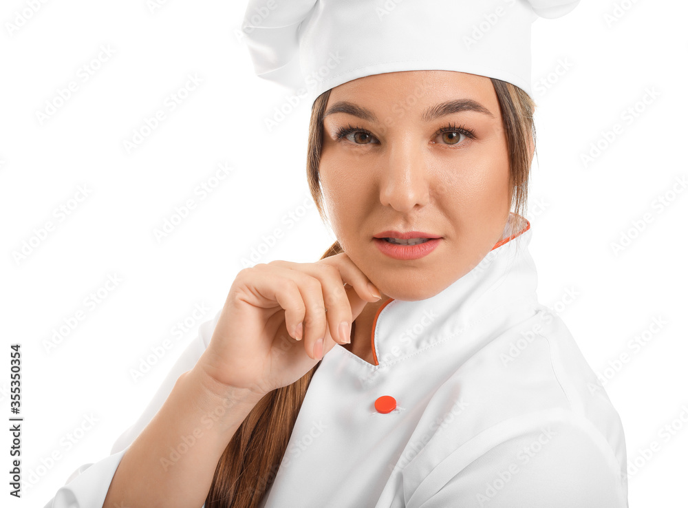Young female chef on white background