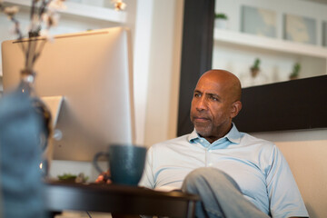 mature african american man working from his home office.