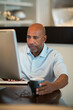 © digitalskillet1 - Mature African American man working from his home office.