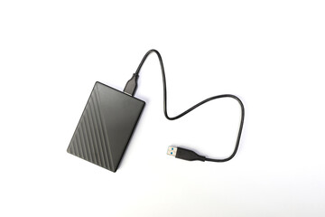 Hard drive or  HDD on white background. external hard drive for storing memory with wire. flat lay