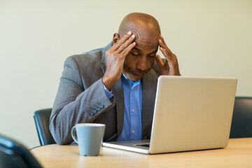 African American man having a difficult time at work.