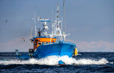 fishing boat returns after fishing to its port. japan. the water area of hokkaido. kunashir strait. 